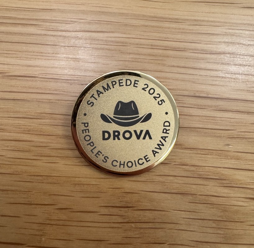 Gold Drova Stampede 2025 People's Choice lapel pin engraved with the drover's hat icon